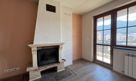 Bright apartment with a fireplace, open-plan kitchen, and balcony with mountain views in a ski resort