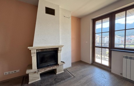 Bright apartment with a fireplace, open-plan kitchen, and balcony with mountain views in a ski resort