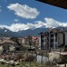 Bright apartment with a fireplace, open-plan kitchen, and balcony with mountain views in a ski resort